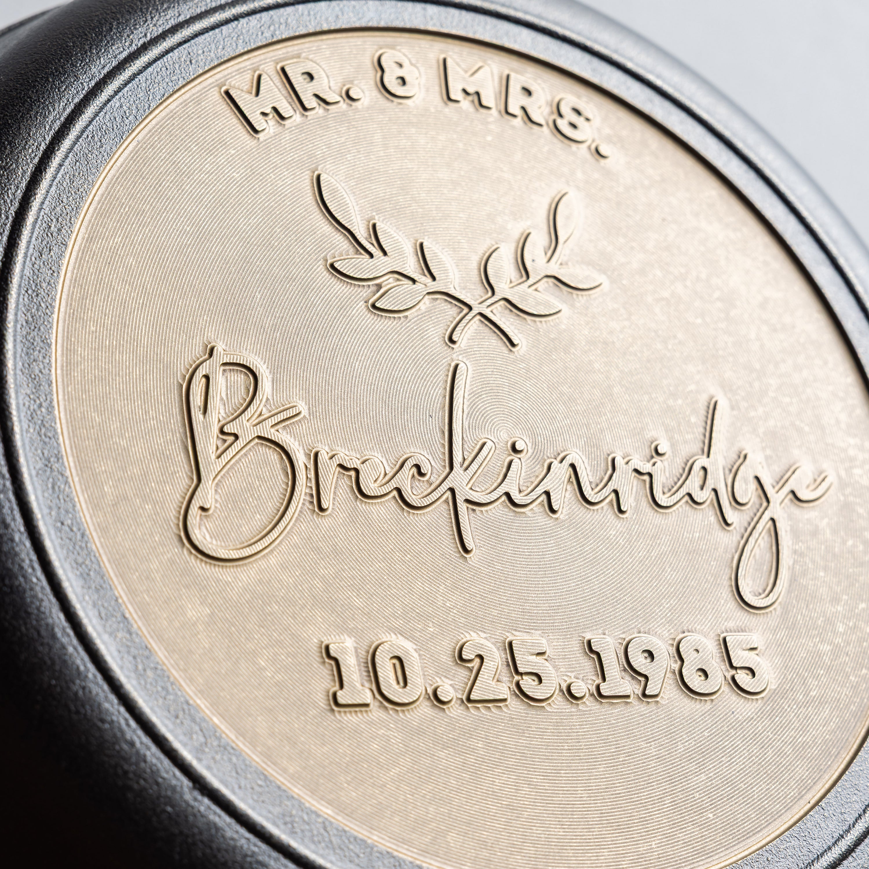 Close-up of personalized wedding skillet with "Mr. & Mrs." in top arc field, the couples last name in cursive for the middle field, and the wedding date underneath.