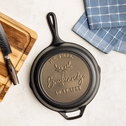 Cast iron skillet with personalized engraving on a kitchen counter
