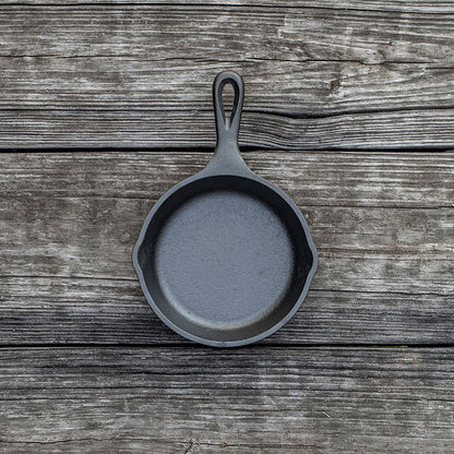 Skillet on wooden background.