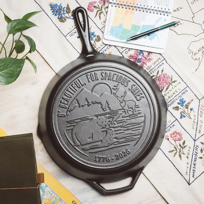 Black cast iron skillet with engraved design on a map background.