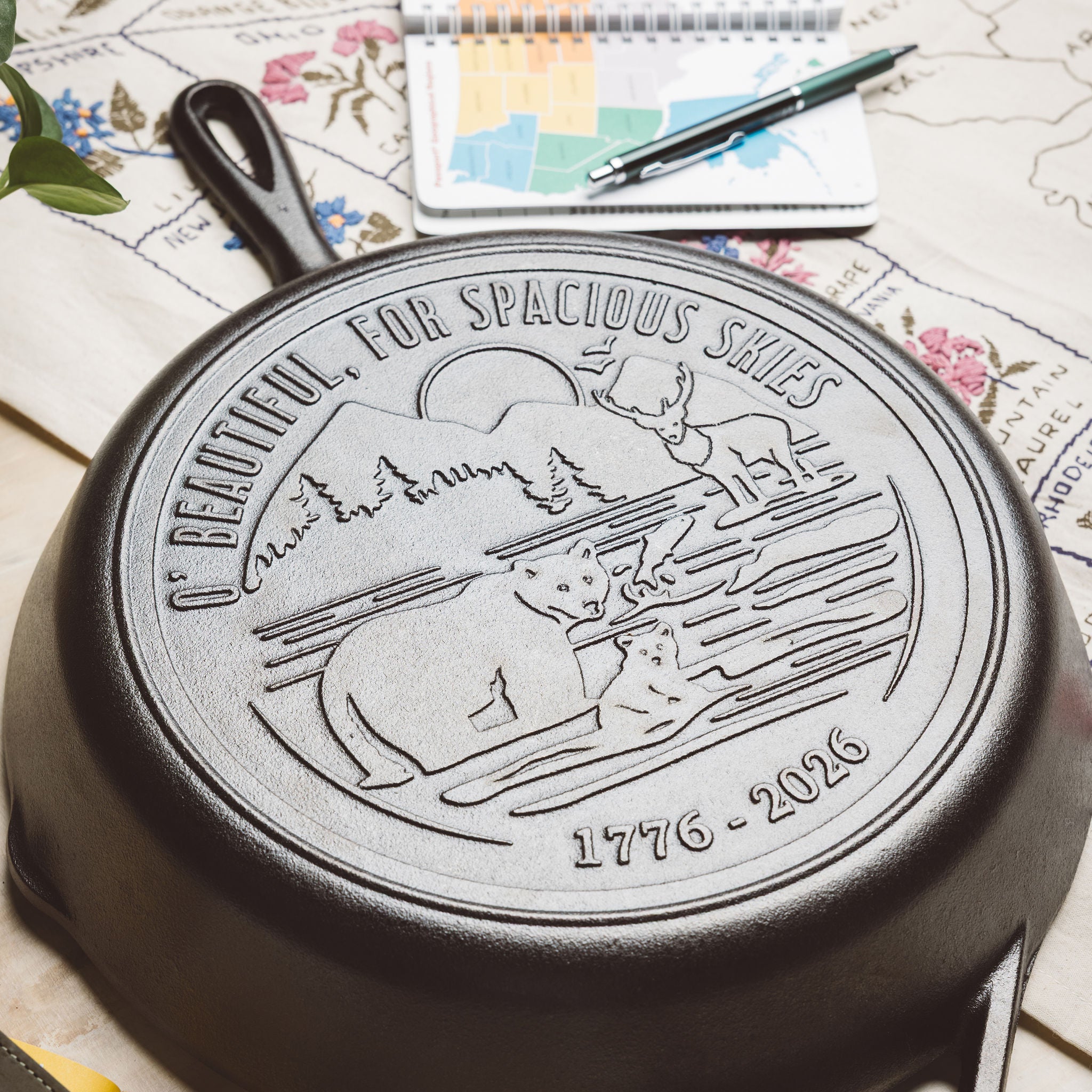 Close-up view of skillet design on a  floral and map background.
