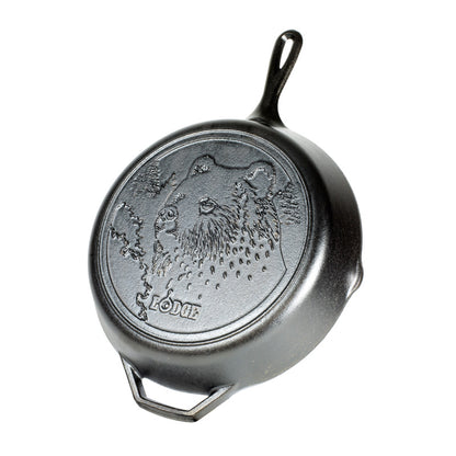 Cast iron skillet with bear design and 'Lodge' branding.