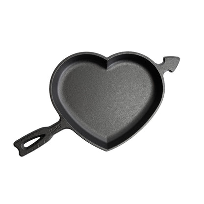 A black heart-shaped cast iron skillet with a handle and arrow design.