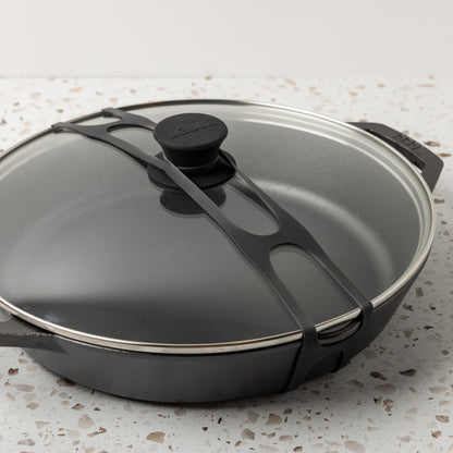 Close up shot of black lid latch being used on our everyday pan and glass lid.