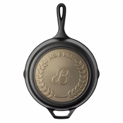 Sample personalized skillet for a married couple, with top text being "Mr. & Mrs." and initial of their last name incenter.