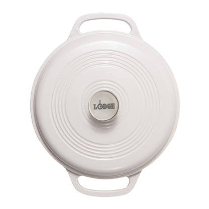 A top-down view of a white Lodge round cast iron Dutch oven lid with two handles and a silver stainless center knob.