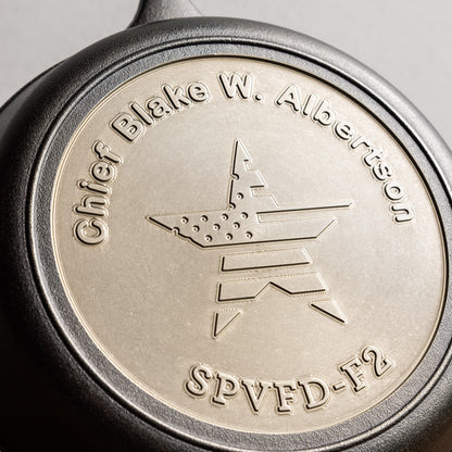 Close-up of a metallic engraving with text and design.