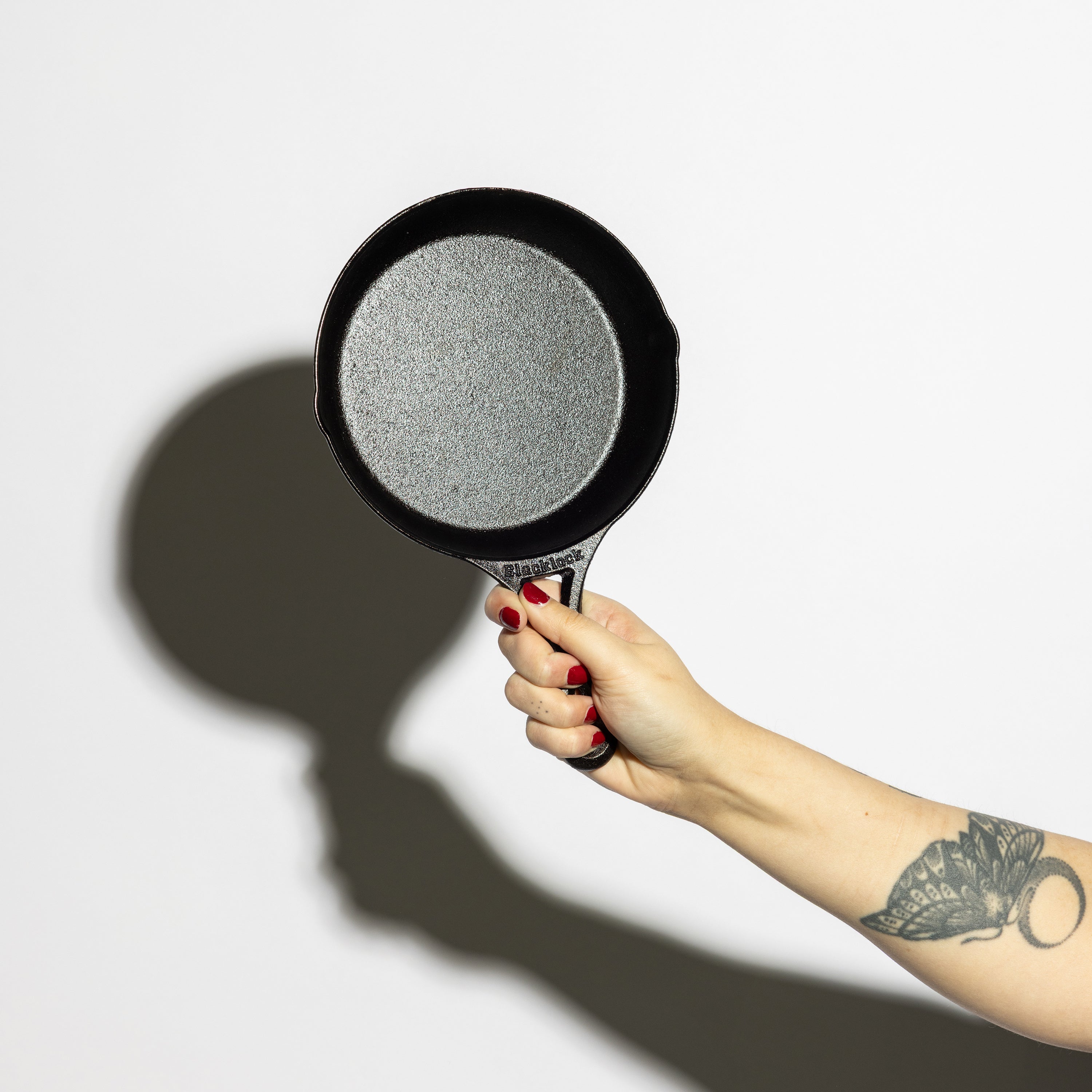 Someone holding skillet, displaying cooking surface.