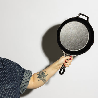 Someone holding skillet and displaying cooking surface.