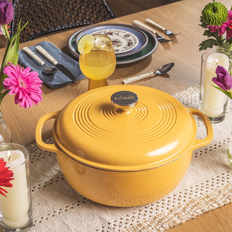 Dutch oven on kitchen table with flowers.