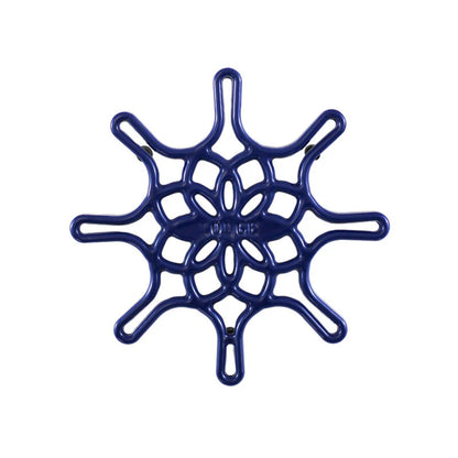 An indigo enameled cast iron trivet with a geometric snowflake-like pattern.