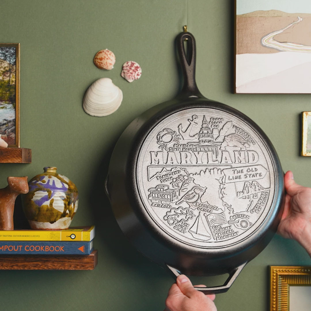 Close up view of the engraved skillet being hung on a wall.