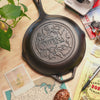 Close-up view of the engraved design on back of skillet.