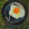 Egg cooking in skillet.