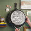 Close up view of engraved design on bottom of skillet.