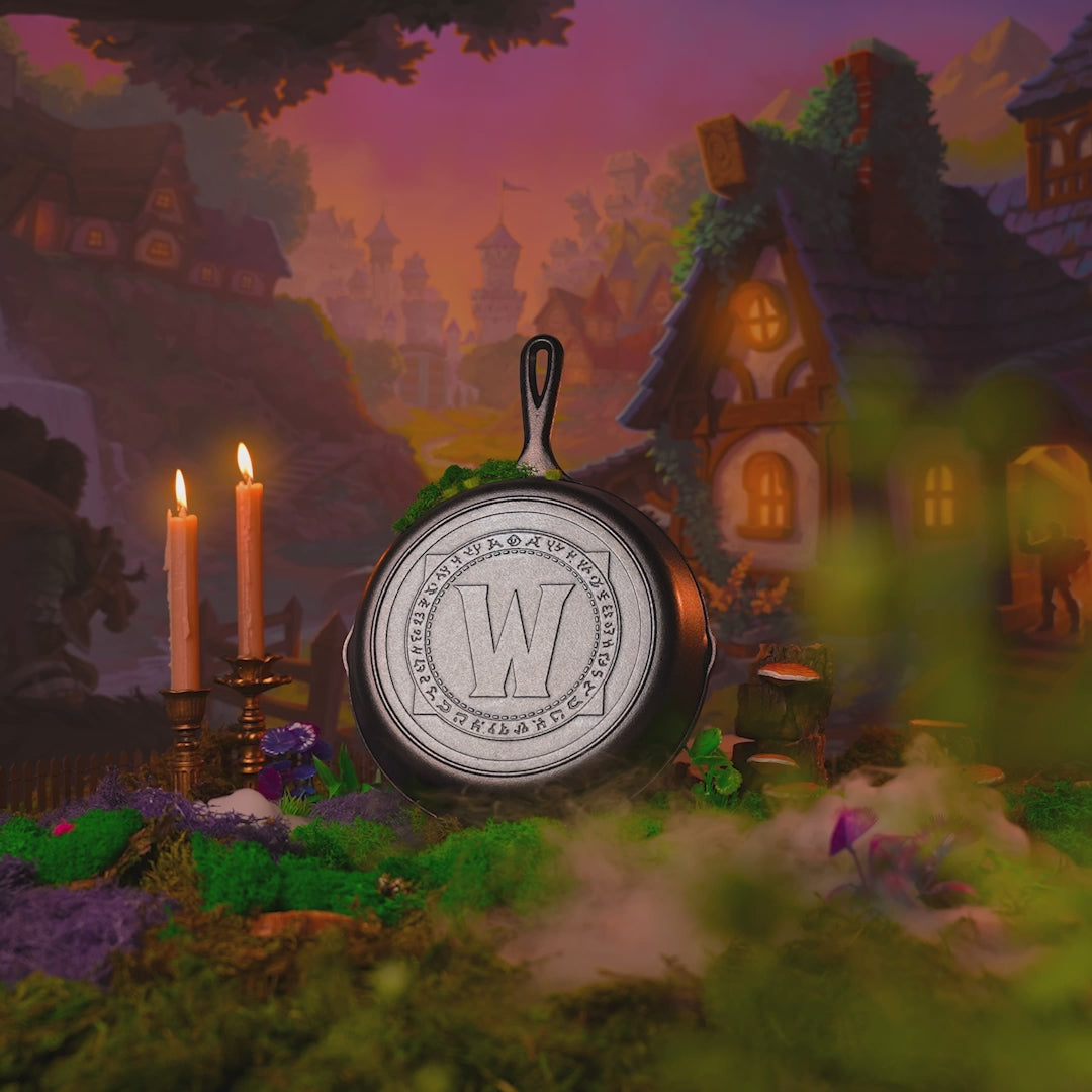 Skillet displayed with fantasy background alongside burning candles and rolling smoke.