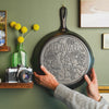 Close up view of state skillet being hung on wall to display.