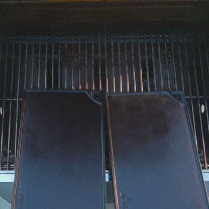 Smash burgers being made on 2 griddles using the grill press.
