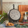 Close up view of the engraved design on bottom of skillet.