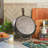 Close up view of the engraved icons on bottom of skillet.