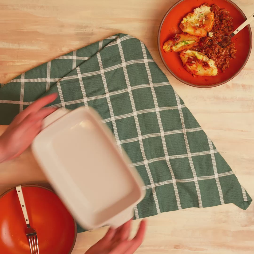 Oyster ceramic casserole dish being placed on counter.