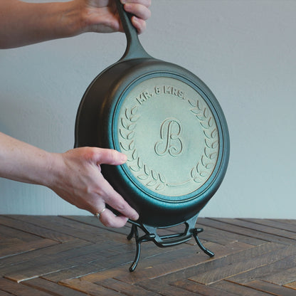 Custom skillet being placed on display stand.