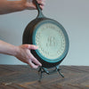 Custom skillet being placed on display stand.