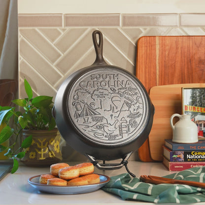 Close-up view of the monuments and icons that are engraved on the bottom of the skillet.