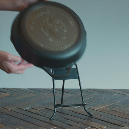Someone placing personalized skillet on display stand to commemorate new home.